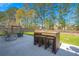 Backyard patio has a high-top dining table, swing, and green lawn at 206 Alpine Rd, Summerville, SC 29485