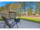 Outdoor patio seating area with fire pit, swing, and fenced yard at 206 Alpine Rd, Summerville, SC 29485