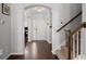 Elegant foyer with hardwood floors, decorative pillars, chandelier and staircase with wooden handrail at 206 Alpine Rd, Summerville, SC 29485