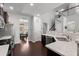 Modern kitchen featuring stainless steel appliances, quartz countertops, dark cabinetry, and a view into the dining room at 206 Alpine Rd, Summerville, SC 29485