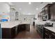 Contemporary kitchen with dark cabinetry, breakfast bar, stainless appliances and views into living room at 206 Alpine Rd, Summerville, SC 29485