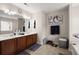 Bathroom featuring dual vanities, large mirror, wall art and fixtures at 210 Sabal Palmetto Ct, Moncks Corner, SC 29461