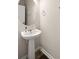 Stylish half bathroom with white pedestal sink, updated fixtures, and a round mirror at 210 Sabal Palmetto Ct, Moncks Corner, SC 29461