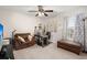 Bedroom featuring a ceiling fan, window with patterned curtains, work desk, leather chair and ottoman at 210 Sabal Palmetto Ct, Moncks Corner, SC 29461