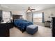 Bedroom featuring a dark wood bed frame, nightstands, ceiling fan and windows with gray curtains at 210 Sabal Palmetto Ct, Moncks Corner, SC 29461