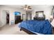 Bedroom boasts dark wood dresser, ceiling fan, large wardrobe and bed with blue bedding at 210 Sabal Palmetto Ct, Moncks Corner, SC 29461