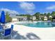 Relaxing community pool area with blue lounge chairs and umbrellas, providing a resort-like experience at 210 Sabal Palmetto Ct, Moncks Corner, SC 29461