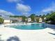 Large community swimming pool with ample lounge chairs and umbrellas, perfect for enjoying sunny days at 210 Sabal Palmetto Ct, Moncks Corner, SC 29461
