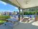 Covered outdoor area with picnic tables overlooking the community pool, ideal for gatherings and relaxation at 210 Sabal Palmetto Ct, Moncks Corner, SC 29461