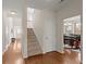 Inviting foyer with hardwood floors, staircase, and views into the dining room and entryway at 210 Sabal Palmetto Ct, Moncks Corner, SC 29461