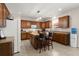 Well-appointed kitchen featuring custom cabinets, a center island with bar seating, and modern appliances at 210 Sabal Palmetto Ct, Moncks Corner, SC 29461