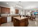 Open-concept kitchen with an island, stainless steel appliances, and views to dining and living areas at 210 Sabal Palmetto Ct, Moncks Corner, SC 29461