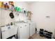 Practical laundry room with washer, dryer, utility sink, and ample storage shelves at 210 Sabal Palmetto Ct, Moncks Corner, SC 29461