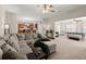 Spacious living room featuring a plush sectional, open layout and flows into the kitchen and game room at 210 Sabal Palmetto Ct, Moncks Corner, SC 29461