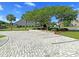 Brick parking area with garden bed and landscaping, offering a charming and practical space for vehicles at 210 Sabal Palmetto Ct, Moncks Corner, SC 29461