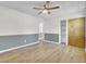 Bedroom featuring hardwood floors, two-tone walls, closet, and a ceiling fan at 213 Braly Dr, Summerville, SC 29485