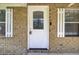 Close-up of a charming front door with decorative glass and brick surround at 213 Braly Dr, Summerville, SC 29485