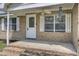 Cozy front porch with brick accents and a ceiling fan for comfortable outdoor living at 213 Braly Dr, Summerville, SC 29485