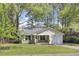 Charming one-story home with brick accents, a well-manicured lawn, and a cozy, covered front porch at 213 Braly Dr, Summerville, SC 29485