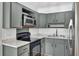 The kitchen features ample gray cabinetry, stainless steel appliances, and plenty of countertop space at 213 Braly Dr, Summerville, SC 29485