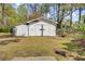 White shed with cross detail on double doors, providing additional storage at 213 Braly Dr, Summerville, SC 29485