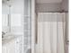 Cozy bathroom with a shower, white cabinets, sink, and a functional storage unit at 2244 Ashley Crossing Dr # 1232, Charleston, SC 29414