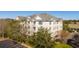 Exterior view of a three story condo building featuring balconies, and lush surrounding landscaping, and private parking at 2244 Ashley Crossing Dr # 1232, Charleston, SC 29414