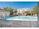 Community pool with pergola and sunning deck in front of the condos at 2244 Ashley Crossing Dr # 1232, Charleston, SC 29414