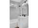 Well-lit bathroom with marble tiling, black fixtures, a white vanity, and a bathtub at 2325 Sorentrue Ave, North Charleston, SC 29405