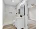 Modern bathroom boasts white vanity, a walk-in shower with marble tile, and wood-look flooring at 2325 Sorentrue Ave, North Charleston, SC 29405