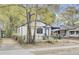 Charming exterior of home with white siding, black trim, and welcoming front porch at 2325 Sorentrue Ave, North Charleston, SC 29405
