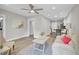 Open-concept living space with wood-look floors, ceiling fan, and a view into the dining and kitchen area at 2325 Sorentrue Ave, North Charleston, SC 29405
