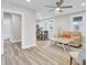 Inviting living room featuring wood-look flooring, a ceiling fan, and an open layout connected to the kitchen at 2325 Sorentrue Ave, North Charleston, SC 29405