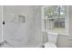 Modern bathroom with marble tile shower and white fixtures at 2916 Louise Dr, North Charleston, SC 29405