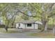 Charming single-story home featuring a black and white design, a mailbox and a mature shady tree in the front yard at 2916 Louise Dr, North Charleston, SC 29405