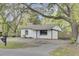 Charming single-story home featuring a black and white design, a mailbox and a mature shady tree in the front yard at 2916 Louise Dr, North Charleston, SC 29405