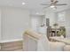 Bright, open-concept living room with modern ceiling fan, wood flooring, dining area, and neutral-colored furniture at 2916 Louise Dr, North Charleston, SC 29405