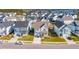 Aerial view of a neighborhood with well-maintained homes, lawns, and waterfront in the background at 2951 Clearwater Dr, Mount Pleasant, SC 29466