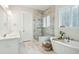 A luxurious bathroom features a glass-enclosed shower, a soaking tub, and elegant fixtures for a spa-like experience at 2951 Clearwater Dr, Mount Pleasant, SC 29466