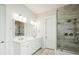 A stylish bathroom features dual sinks, a walk-in shower, and sleek fixtures, creating a functional and elegant space at 2951 Clearwater Dr, Mount Pleasant, SC 29466
