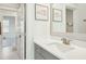 Bright bathroom with quartz countertops, gray cabinets, and decorative framed prints at 2951 Clearwater Dr, Mount Pleasant, SC 29466