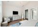 A spacious bedroom boasts neutral tones, with a TV and an open doorway to a luxurious bathroom at 2951 Clearwater Dr, Mount Pleasant, SC 29466
