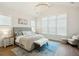 A bright and airy bedroom features a tufted headboard, a soft rug, and large windows with natural light at 2951 Clearwater Dr, Mount Pleasant, SC 29466