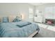 Serene bedroom with a cozy bed, soft blue accents, and natural light from the windows at 2951 Clearwater Dr, Mount Pleasant, SC 29466