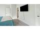 Bedroom features a large flatscreen TV, carpeting, and entryways to additional rooms at 2951 Clearwater Dr, Mount Pleasant, SC 29466