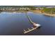 An aerial view captures the long wooden pier with docks, extending into the water to boat and enjoy waterfront views at 2951 Clearwater Dr, Mount Pleasant, SC 29466