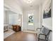 Inviting foyer with hardwood floors, a bench, and view of a living space filled with natural light at 2951 Clearwater Dr, Mount Pleasant, SC 29466