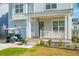 Charming two-story home with a welcoming front porch, manicured lawn, and a golf cart in the driveway at 2951 Clearwater Dr, Mount Pleasant, SC 29466