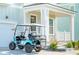 Close up view of a golf cart parked in front of a light blue home with a welcoming front porch at 2951 Clearwater Dr, Mount Pleasant, SC 29466