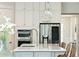 Modern kitchen island with stainless steel appliances and a view of the stainless steel refrigerator at 2951 Clearwater Dr, Mount Pleasant, SC 29466